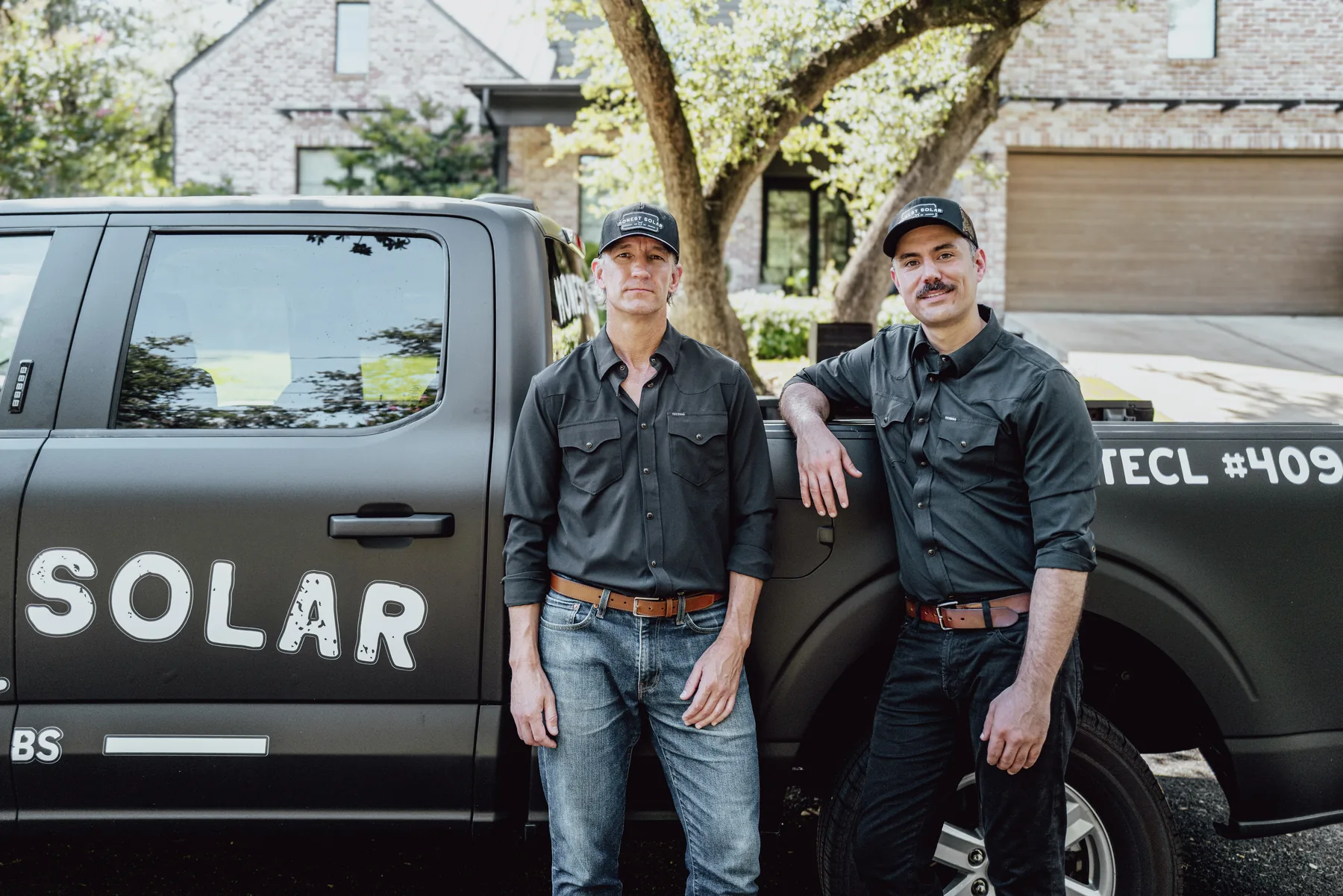 Honest Solar founders Jonathan and Patrick with their truck in an Austin neighborhood