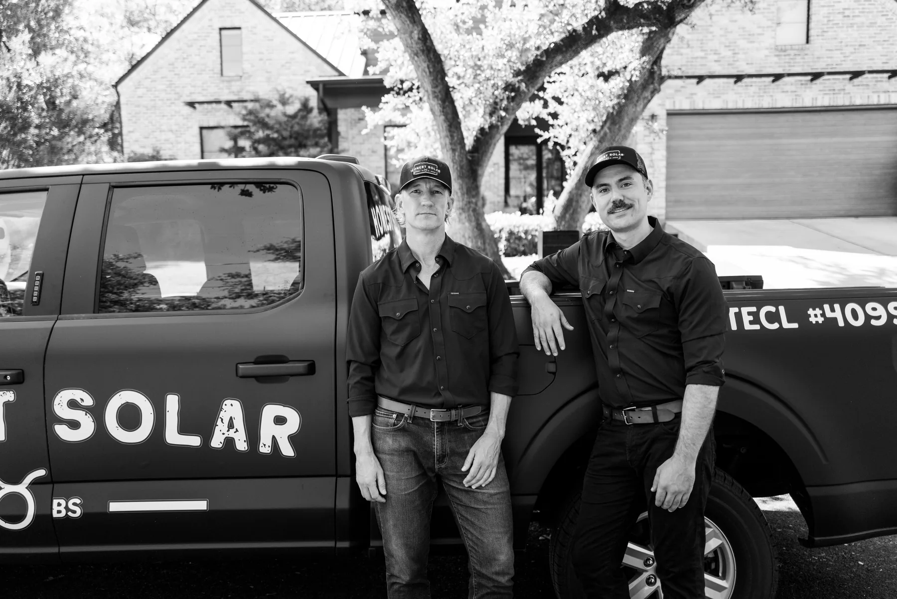 Honest Solar founders Jonathan and Patrick with their truck in an Austin neighborhood